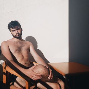 Young man sitting on seat at home