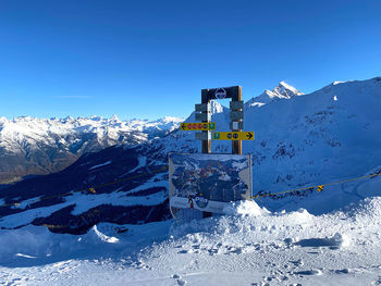 Snow covered mountain against clear blue sky