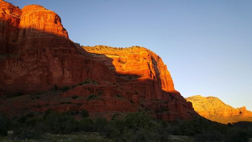 Rock formations on mountain against clear sky