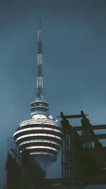 Low angle view of illuminated tower against sky at night