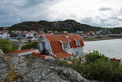 High angle view of townscape by sea against sky