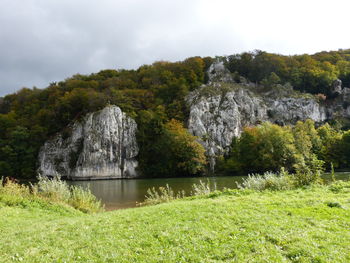 Scenic view of lake and rocks against sky