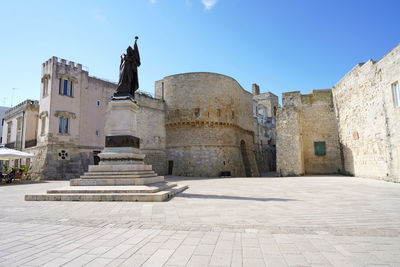 Lungomare degli eroi with monument on promenade with torre alfonsina tower in otranto, italy