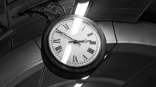 Low angle view of clock on ceiling