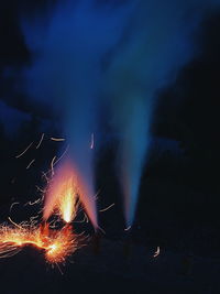 Illuminated fireworks against sky at night