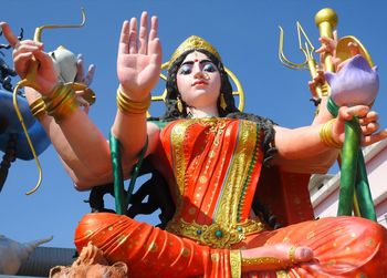 Low angle view of statue against temple