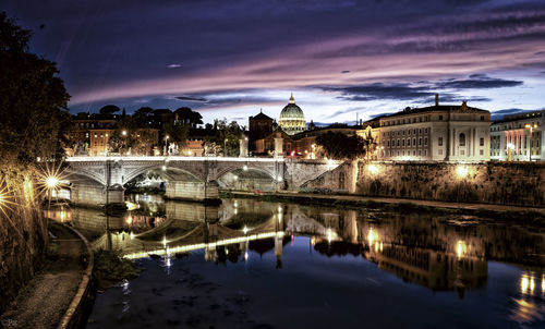 Ponte sant angelo over tiber river in city at night