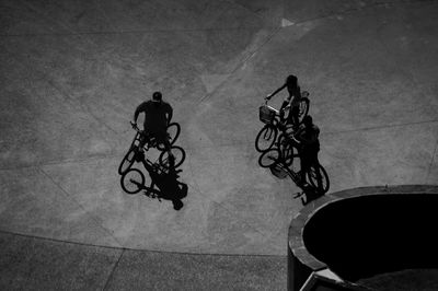 High angle view of friends with bicycles on street