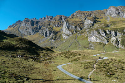 Scenic view of mountains against clear blue sky