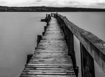 Tranquil scene with empty old wooden jetty on sea