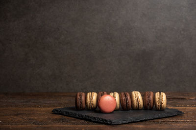 Close-up of cake on table against black background