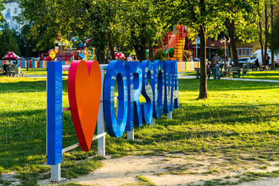 Multi colored flags hanging in park