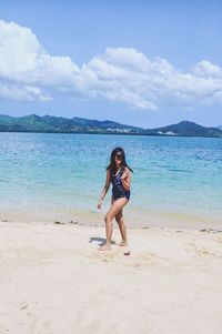 Full length of young woman at beach