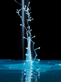 Close-up of splashing water over black background