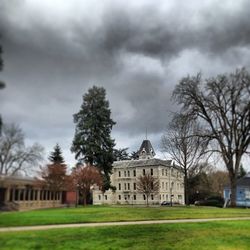 Buildings against cloudy sky