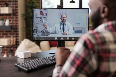 Midsection of man using laptop at office