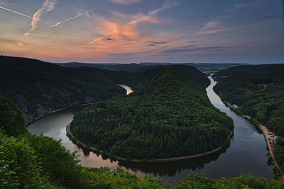 Scenic view of river loop against sky during sunrise