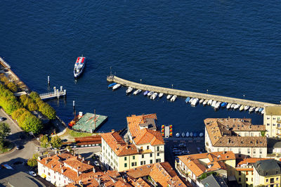 High angle view of sea with rooftops in foreground