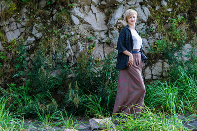 Portrait of woman standing against plants