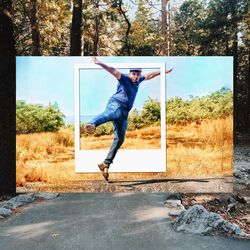 Full length of man jumping on road against trees