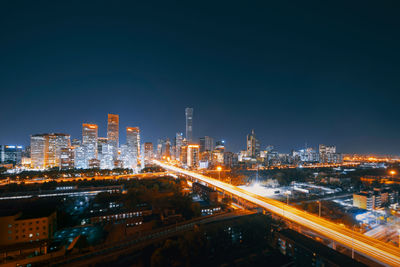 High angle view of illuminated buildings in city at night