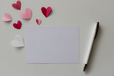 Directly above shot of heart shapes on white background