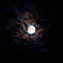Low angle view of illuminated moon against sky at night