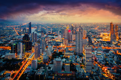 High angle view of illuminated city buildings against sky