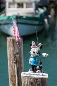 Close-up of toy on wooden post