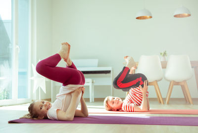 Women lying down on floor at home