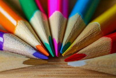 Close-up of multi colored pencils on table