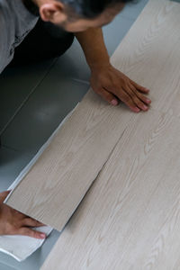 High angle view of carpenter holding plank