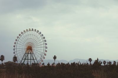 Low angle view of ferris wheel against sky