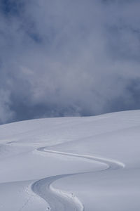 Scenic view of snow covered mountains against sky