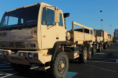 Military vehicles on road against sky
