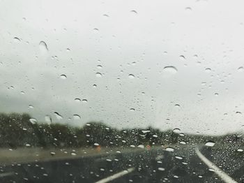 Full frame shot of wet glass window in rainy season