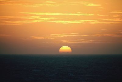 Scenic view of sea against orange sky