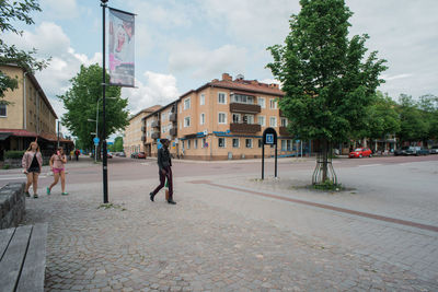 People in city against sky