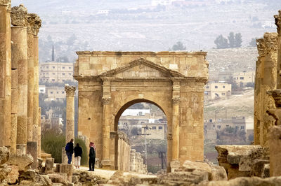 People walking in historic building of jerash archeological site, jordan