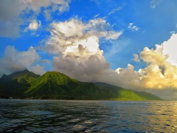 Scenic view of sea and mountains against sky