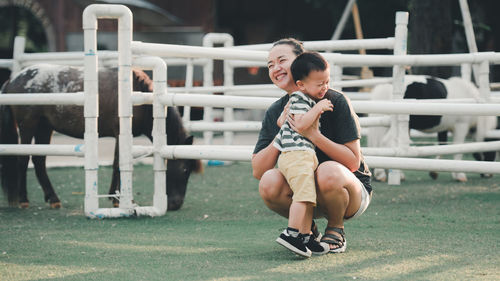 Cheerful mother and son at ranch
