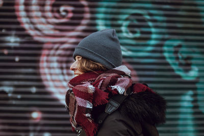 Midsection of woman standing against wall