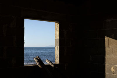 View of sea seen through window