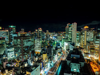 High angle view of illuminated buildings in city at night