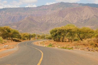 An empty highway against a mountain background in iten - kabarnet road, baringo county, kenya