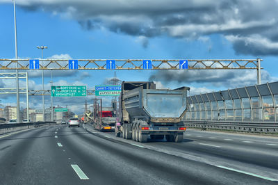 Road by bridge against sky in city