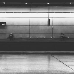 Two people waiting at railway station