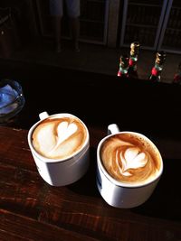 High angle view of froth art on latte at table