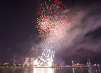 Low angle view of firework display at night