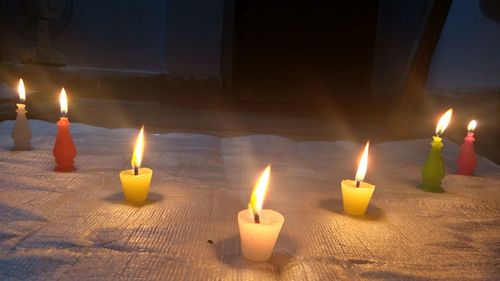 Close-up of burning candles at home
